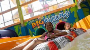 Two girls in blow up tubes on a waterslide